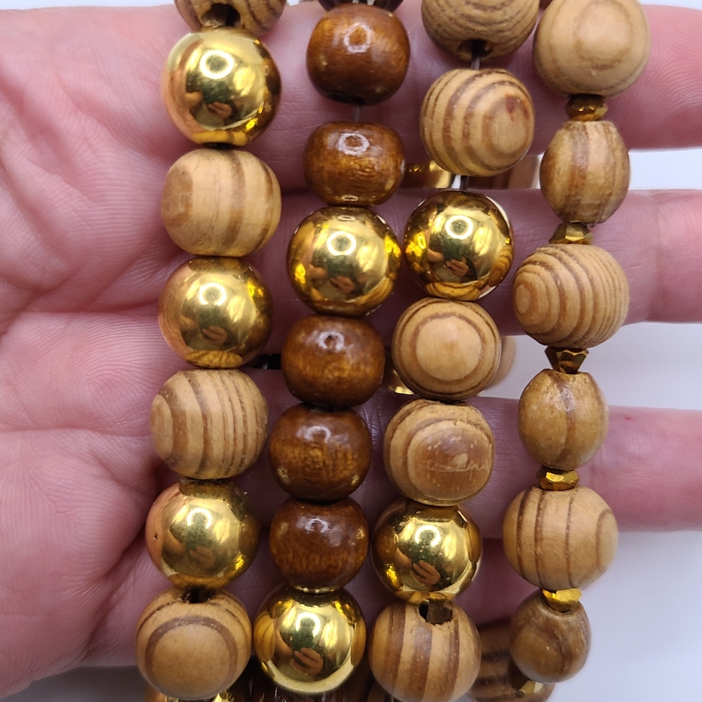 4 bracelets. Woody. Brown and gold. Worn together or individually. Stretchy.